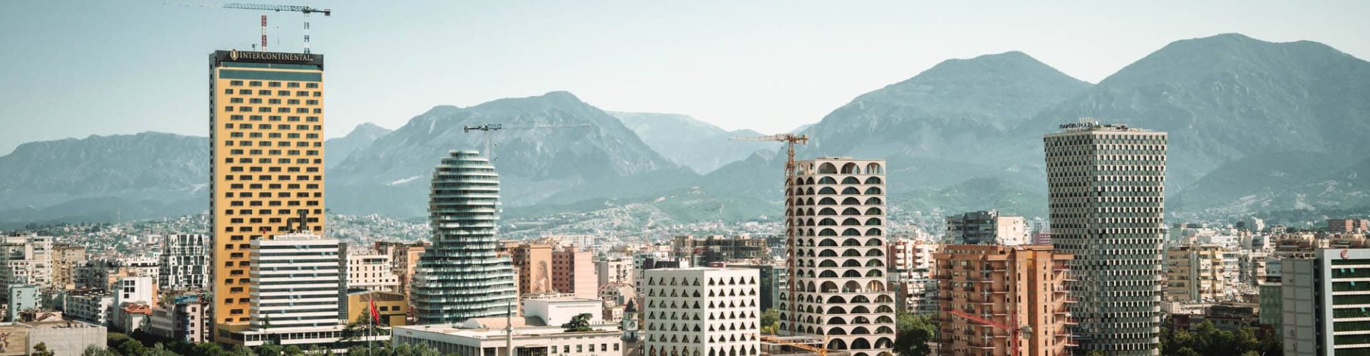 Scenic view of Tirana cityscape at sunset